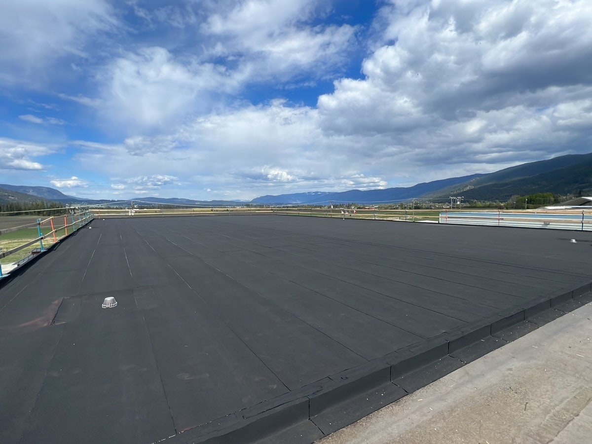 Two-ply SBS on an industrial building, the valley beyond