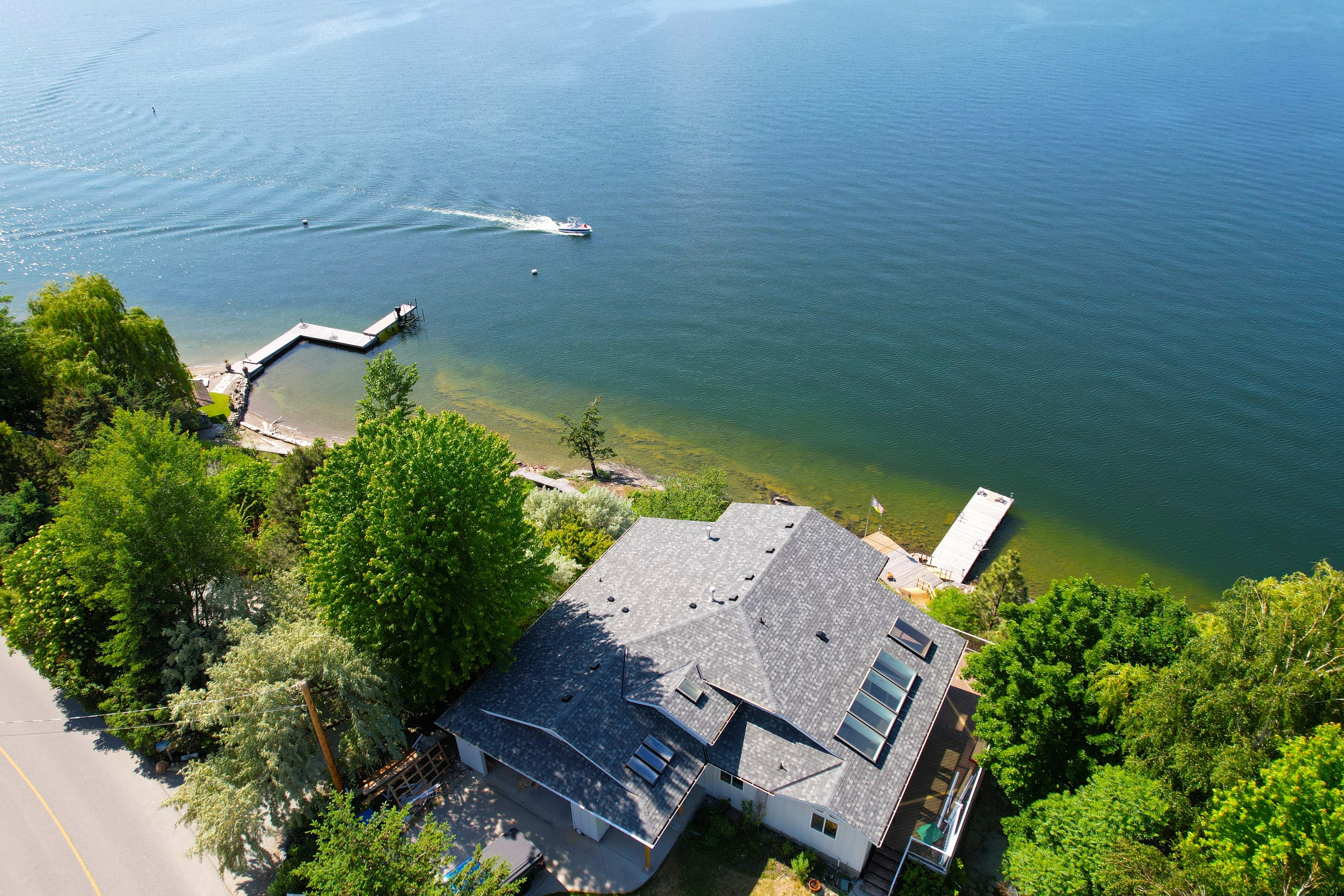 Pitched asphalt shingle roof overlooking Okanagan Lake