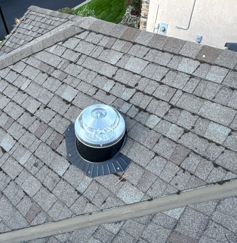 Tubular skylight dome and its flashing on a shingle roof