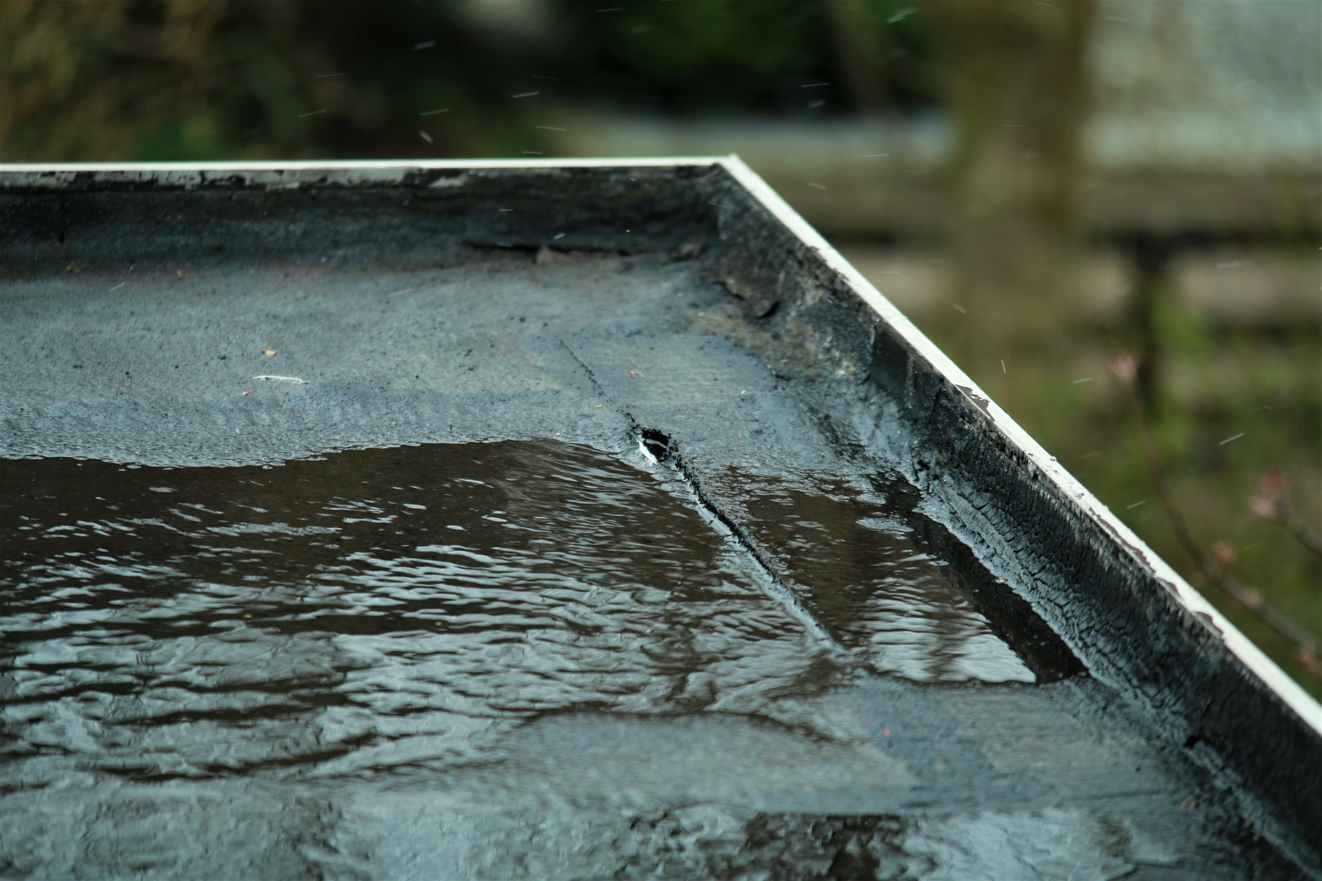 Close-up repair of a failed seam on a torch-applied membrane roof
