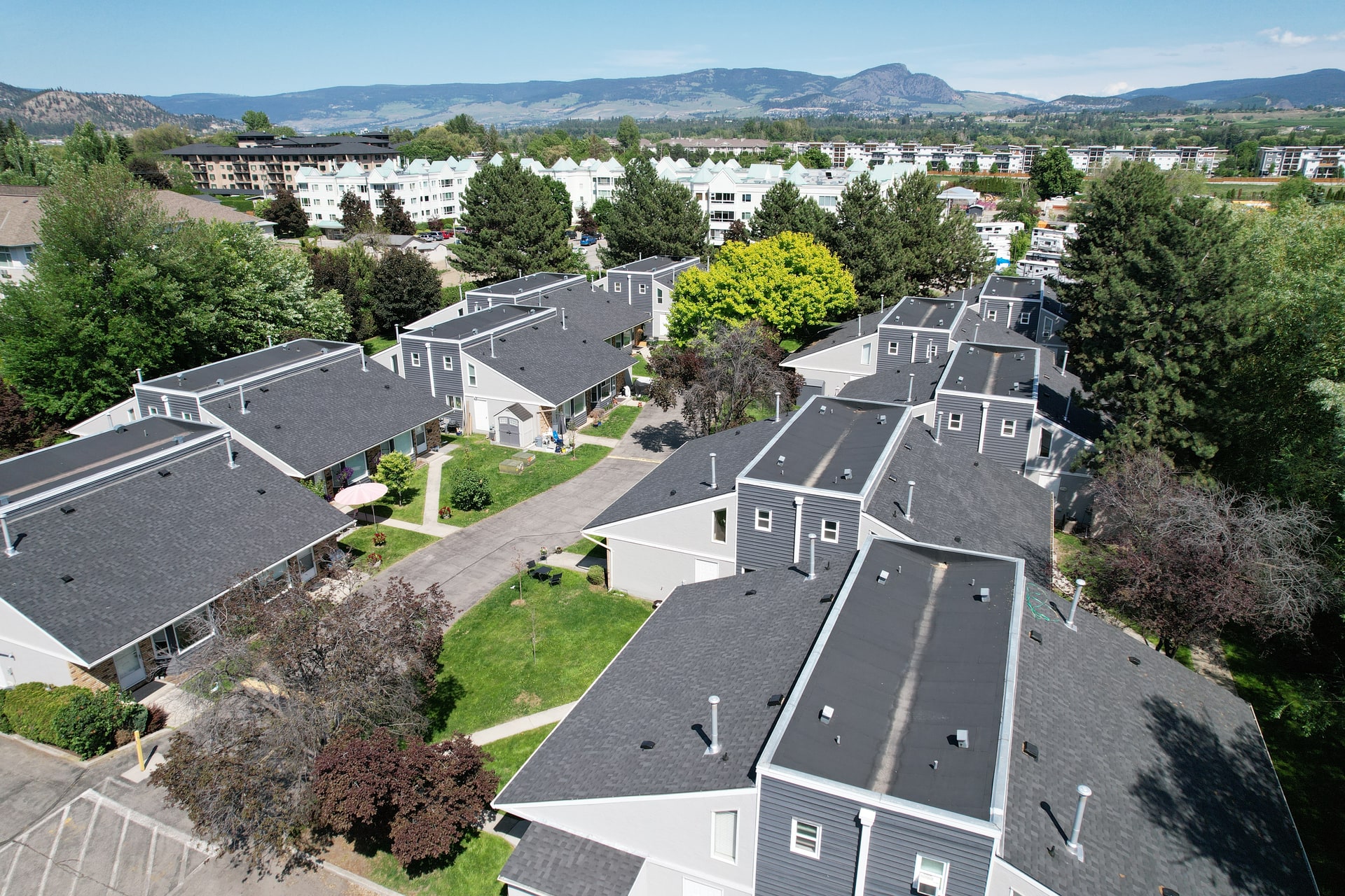 A townhome complex with new shingle roofs, seen from above